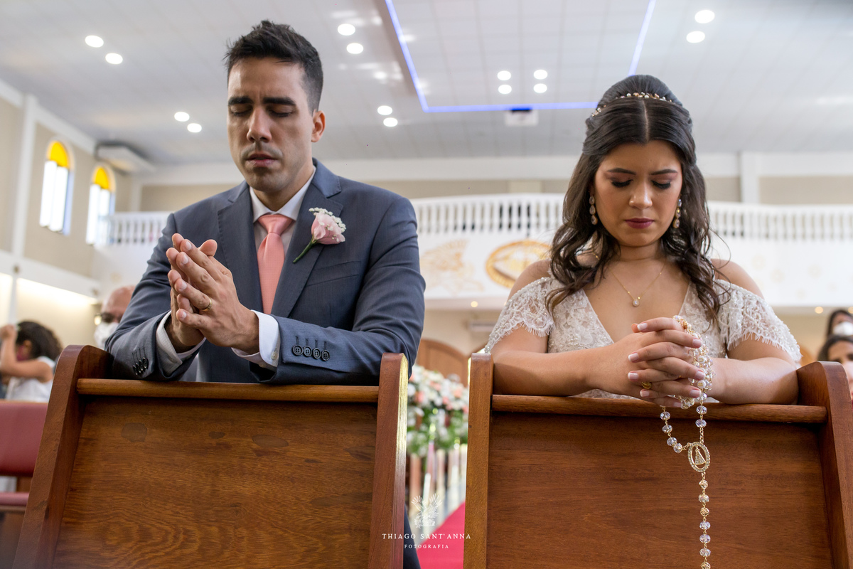 noivos realizam prece ajoelhados no altar