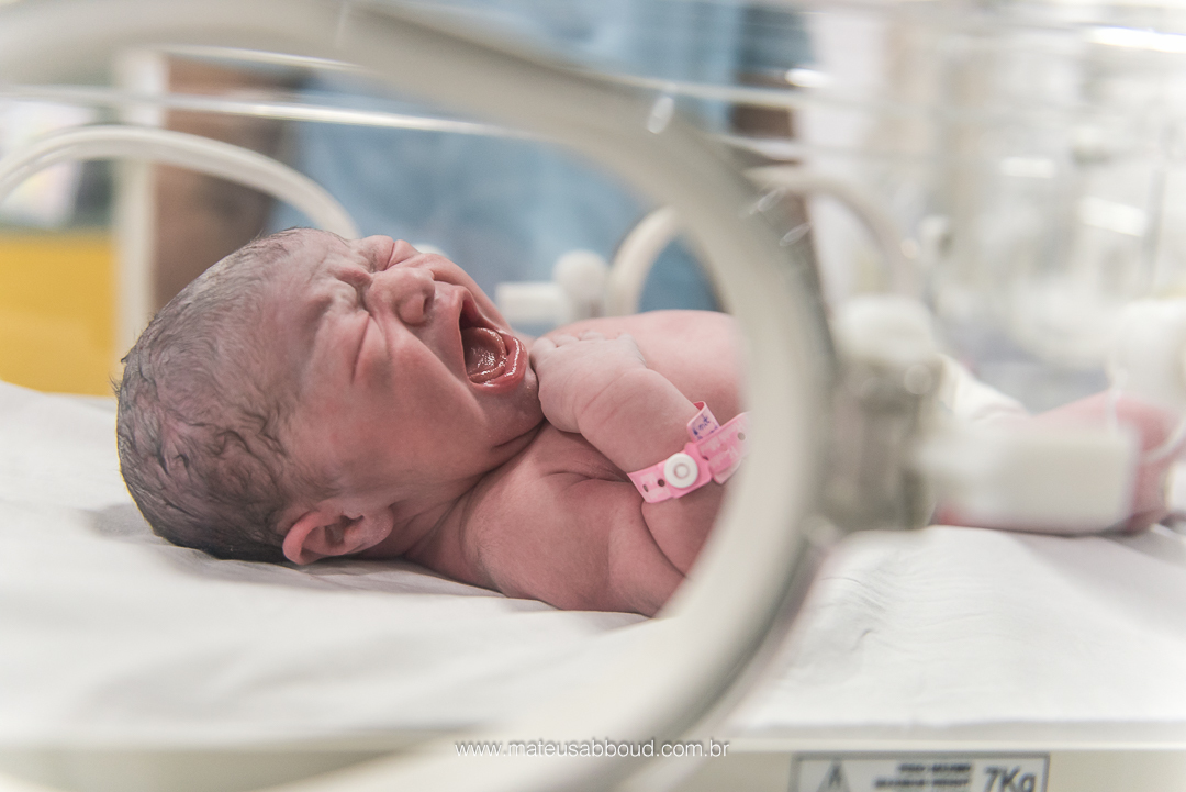 Bebê chorando dentro da encubadora no berçário.