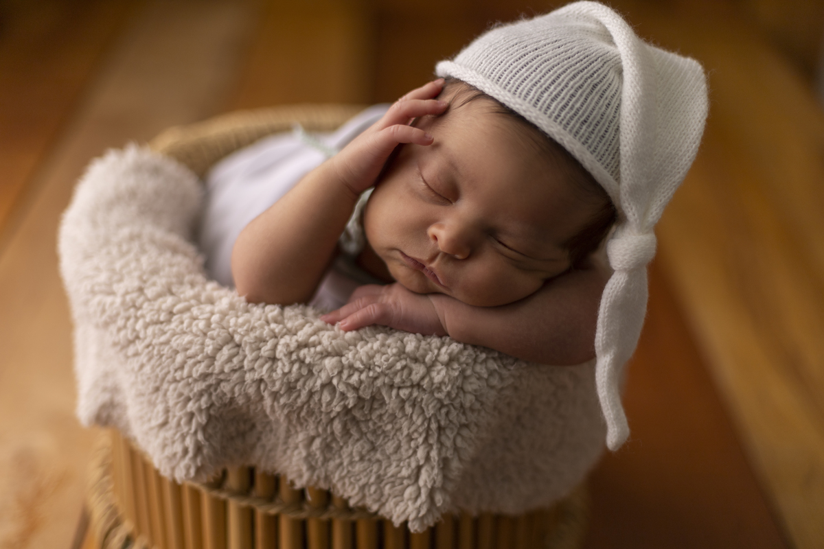 newborn no pop tina marrom com gorro na cabeça