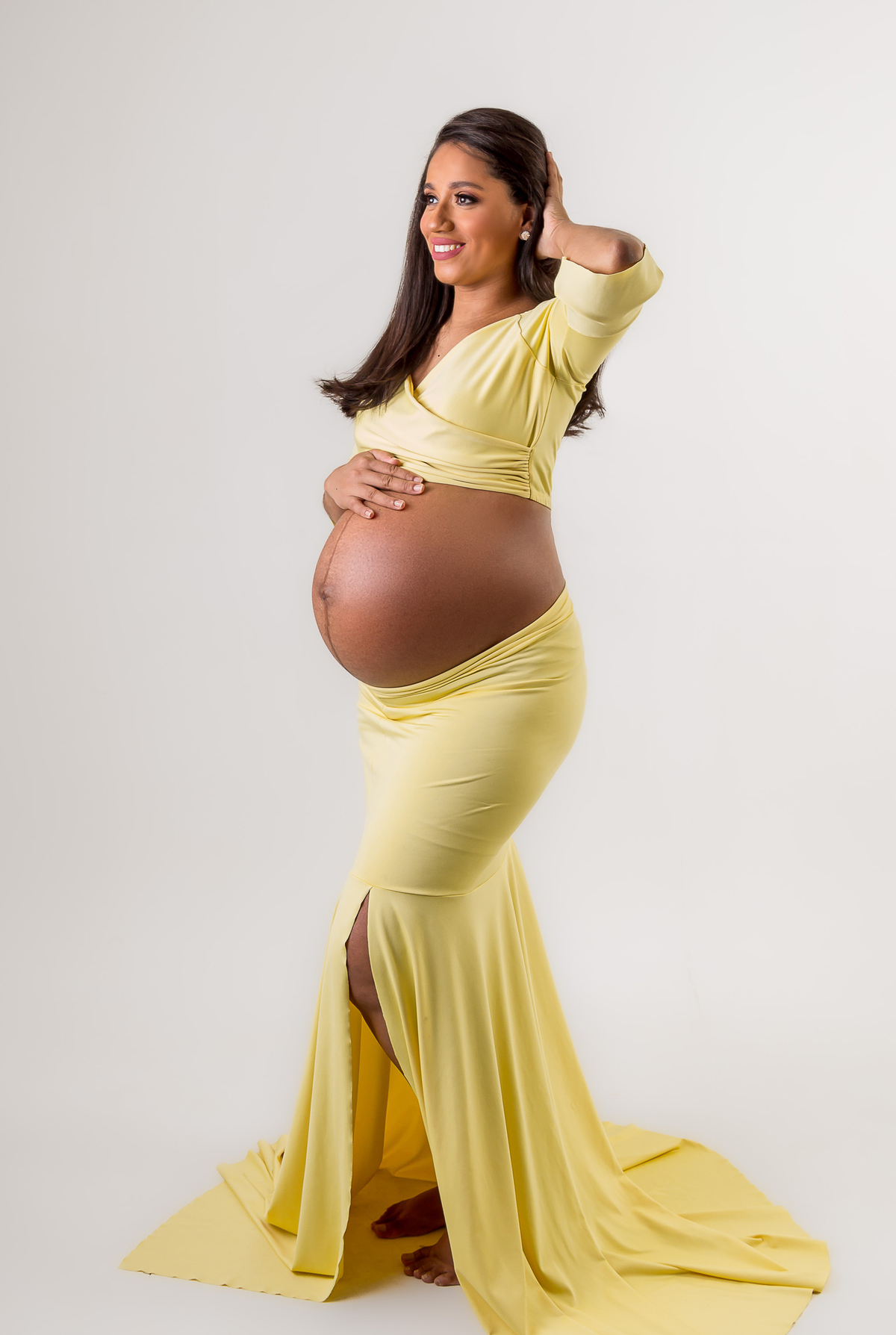 gestante com a mão da barriga e outra no cabelo