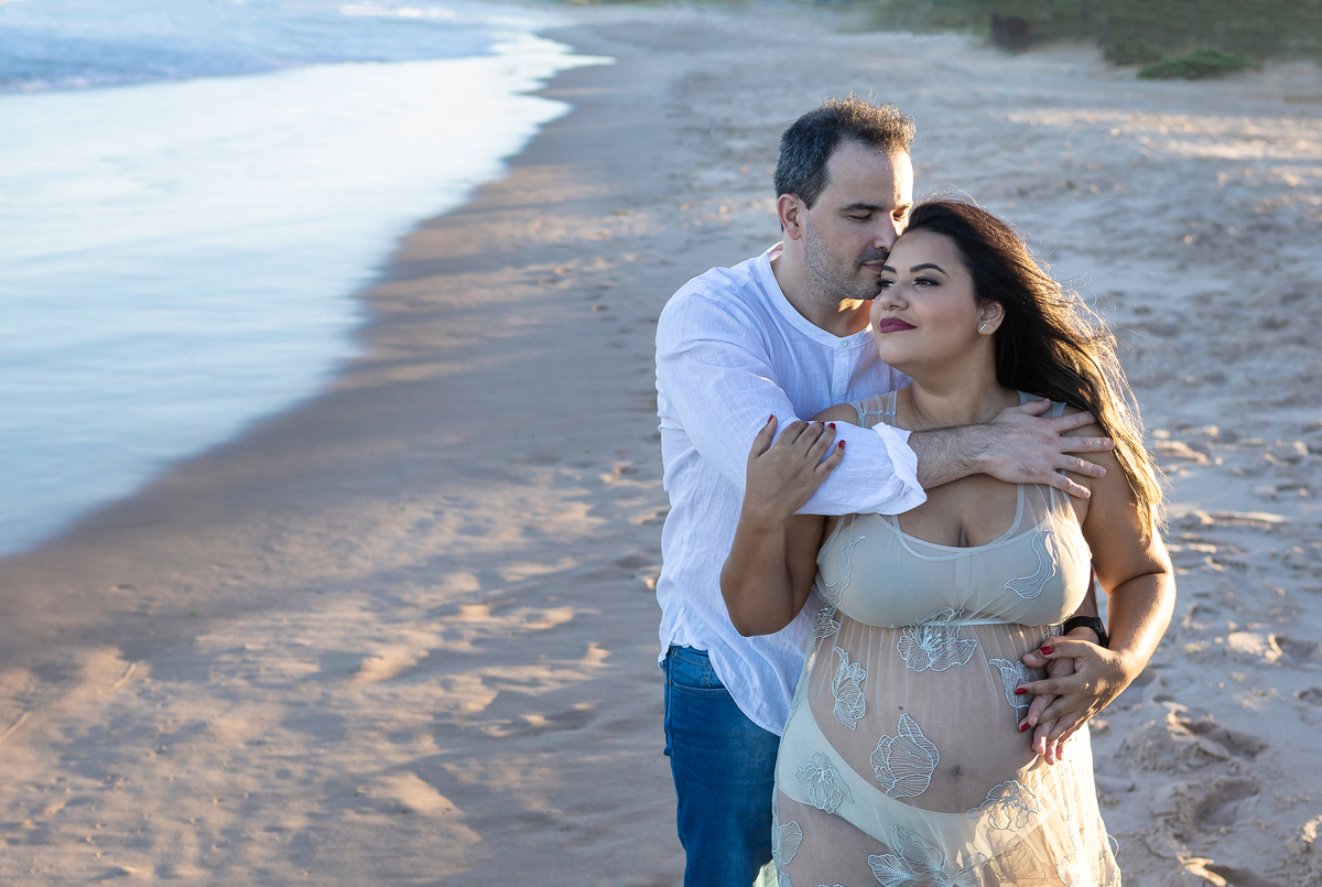 papai e mamãe abraçando na beira do mar