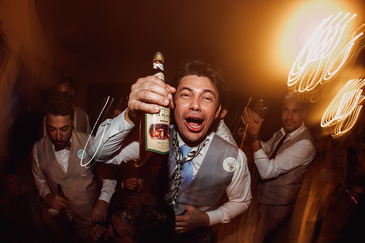 Noivo dançando na pista de dança com bebida