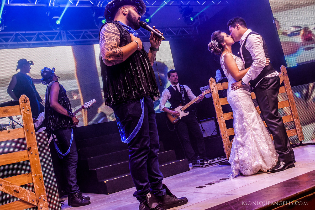 Os noivos se beijando durante apresentação