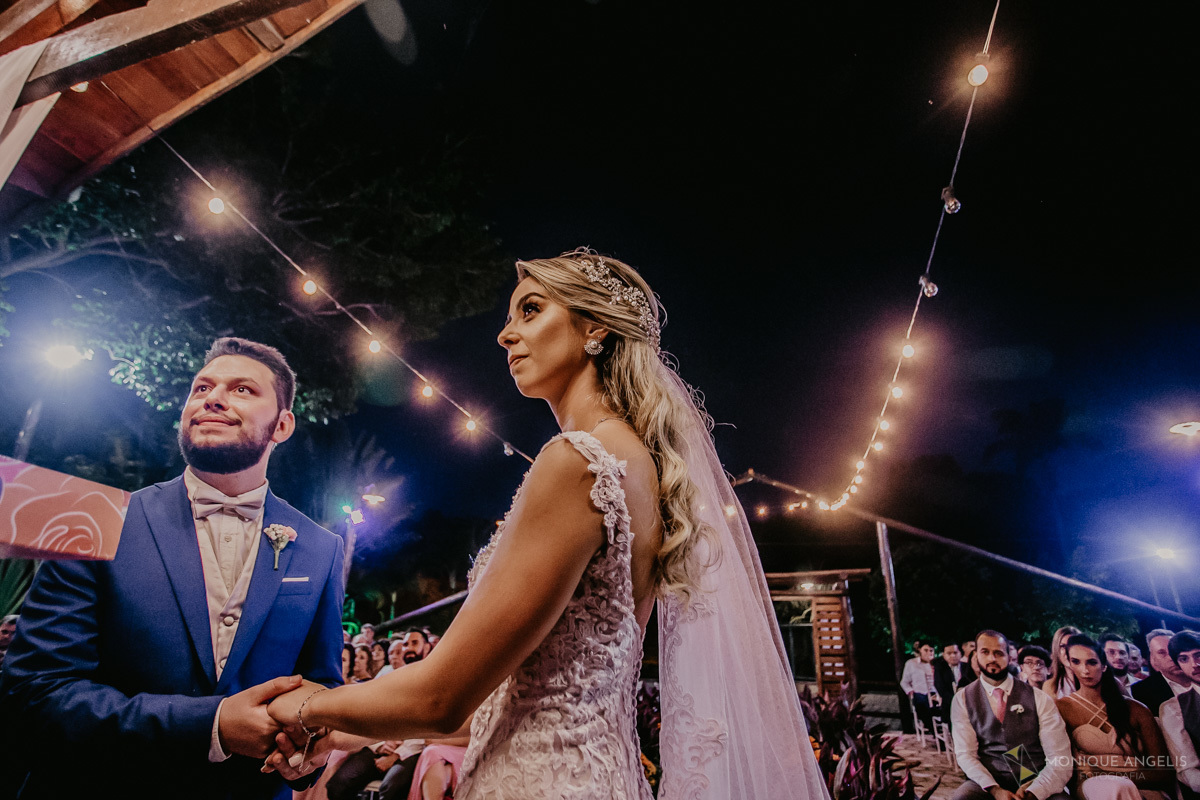casal de noivos de mãos dadas durante a cerimônia de casamento no Espaço Badulaque Eventos