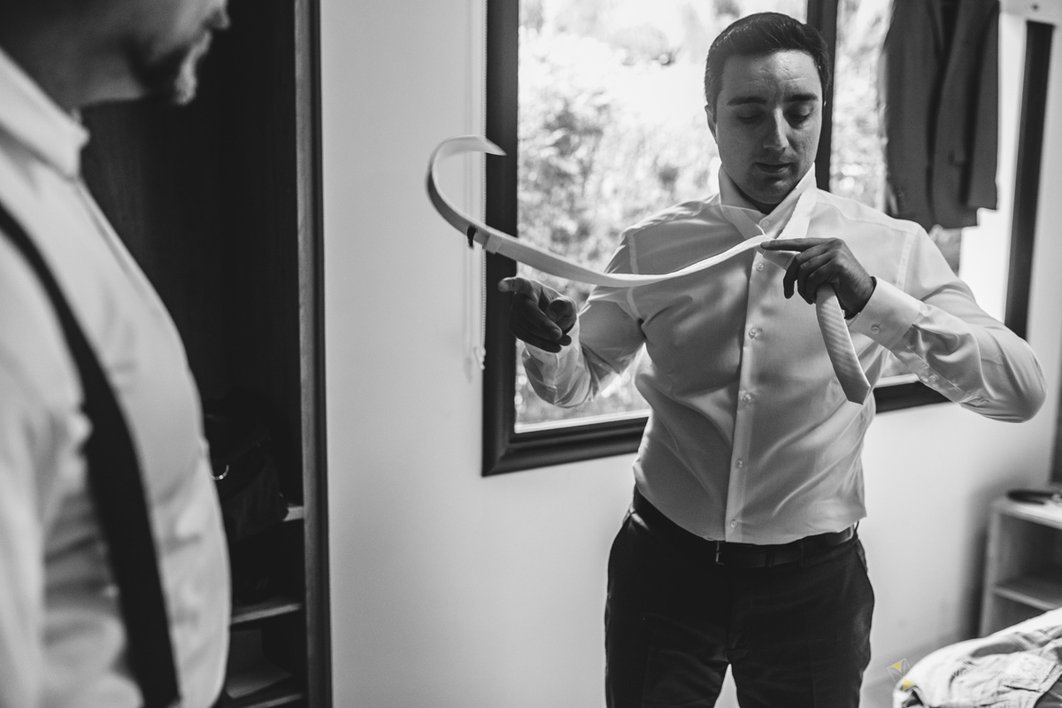 noivo arrumando gravata durante o making