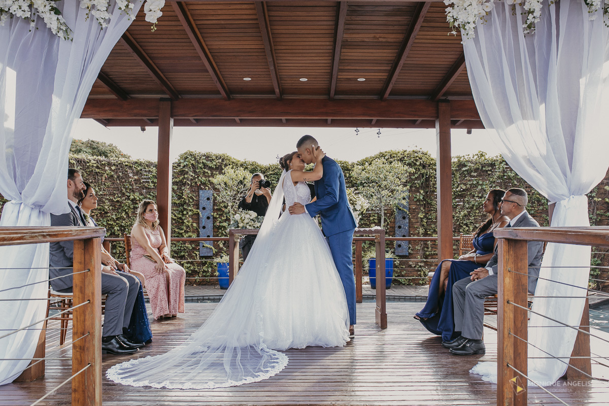 O beijo do casal de Noivos durante a cerimônia de casamento no Villa Harmonia Eventos