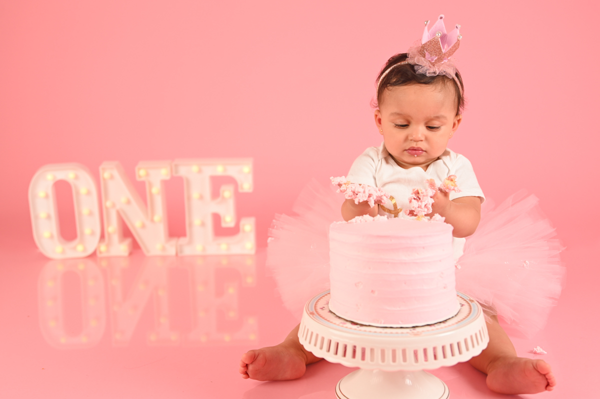 ballerina girl smash cake photo shoot solid pink background  little one 
kids photographer in CT