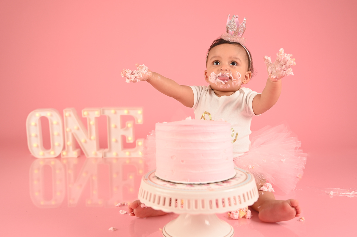 ballerina girl smash cake photo shoot solid pink background  little one 