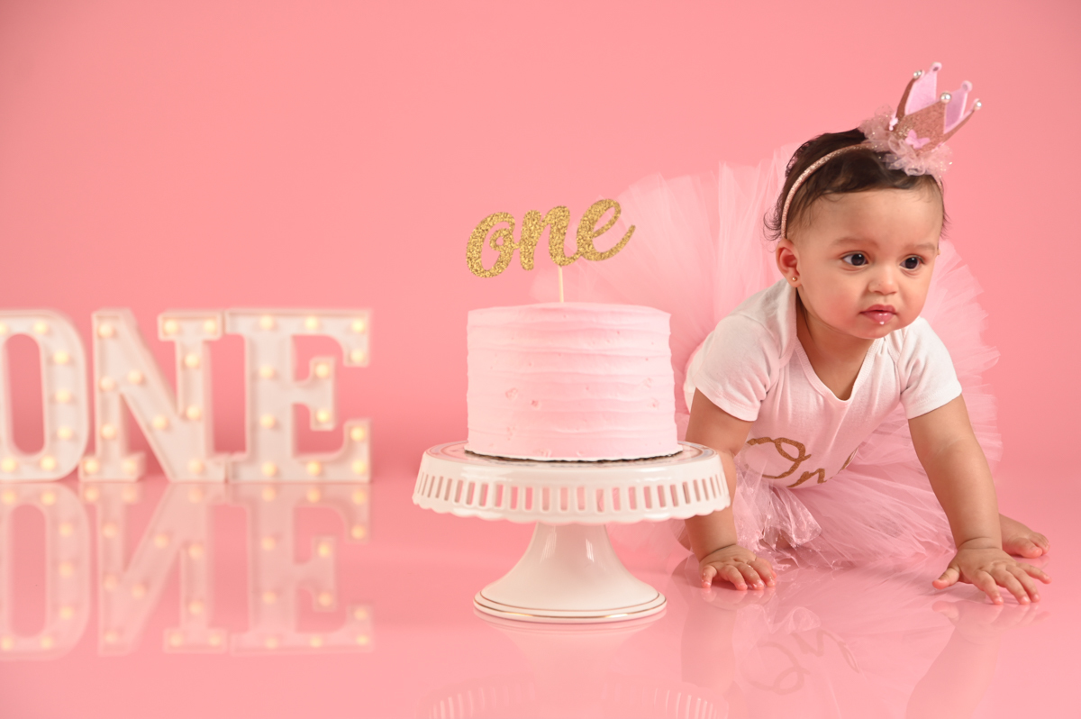 ballerina girl smash cake photo shoot solid pink background  little  one 
kids photographer in CT