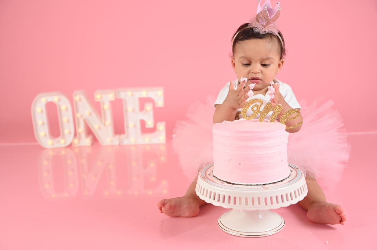 ballerina girl smash cake photo shoot solid pink background  little one 