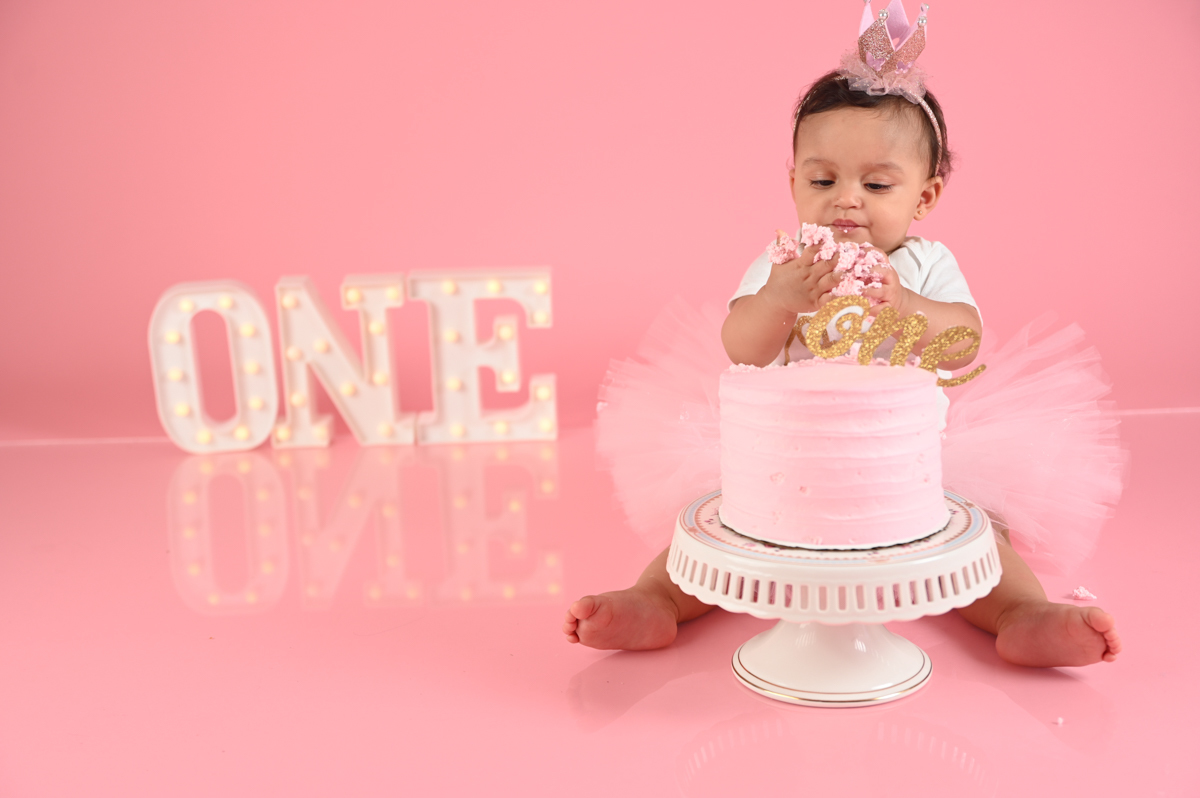 ballerina girl smash cake photo shoot solid pink background  little one 