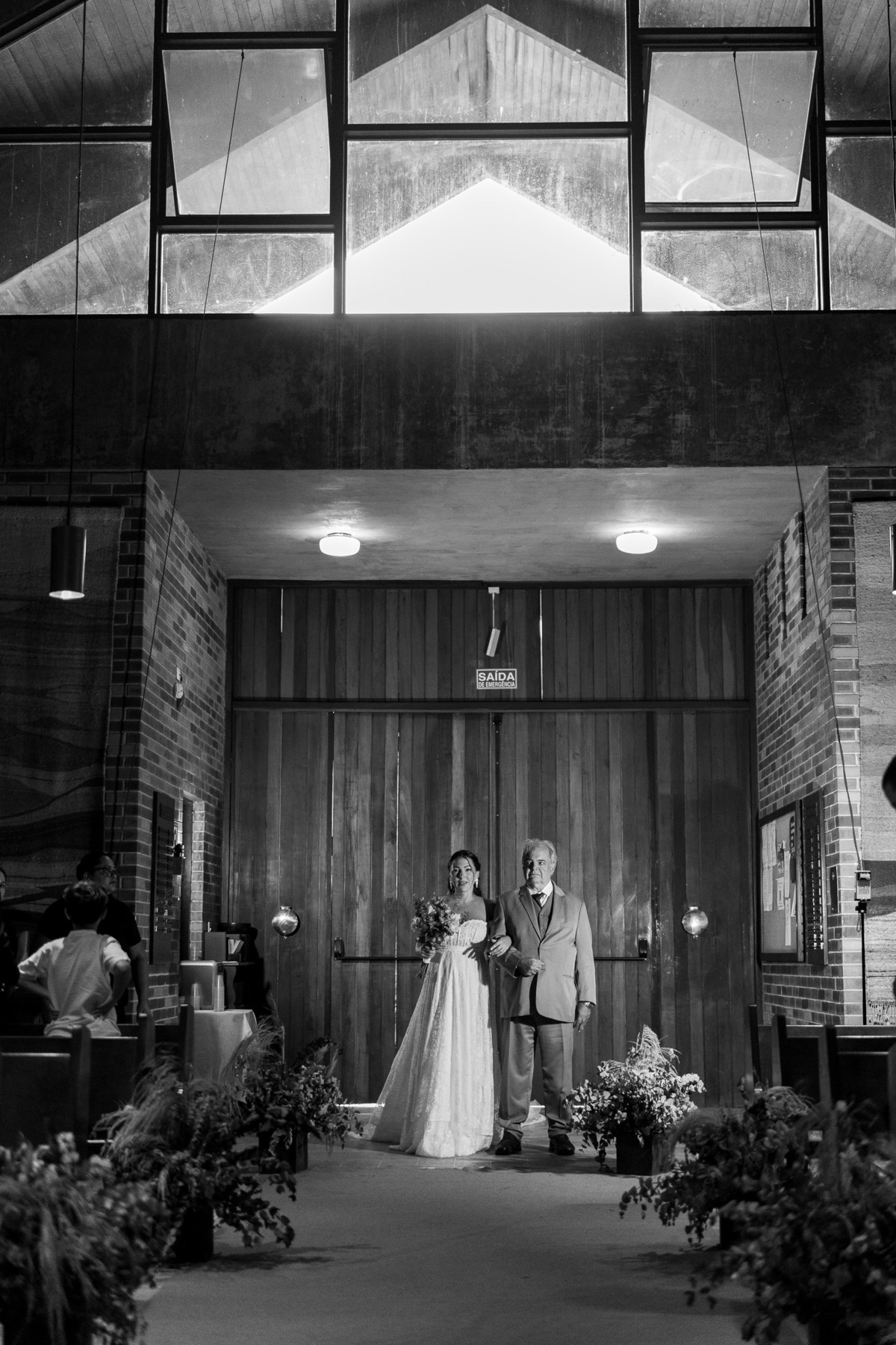 Foto que registra a entrada da noiva, no início do corredor da igreja. Momento de muita emoção.