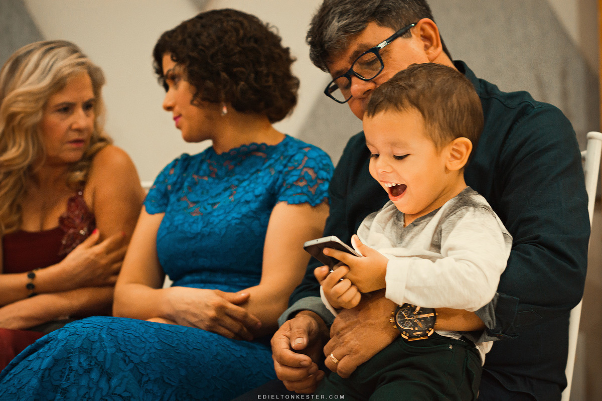 criança brincando no celular e sorrindo
