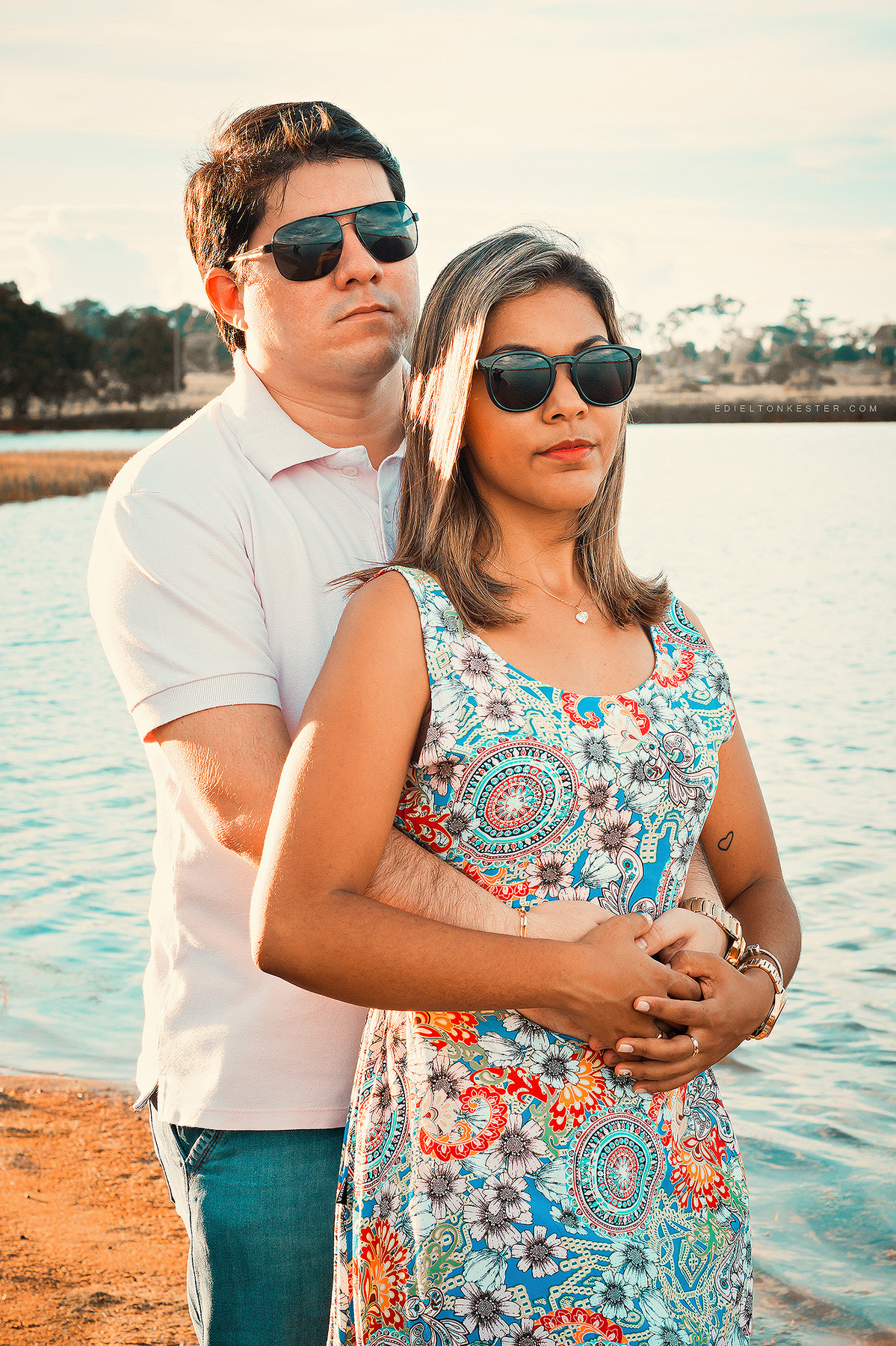 noivos abraçados e caminhando na praia