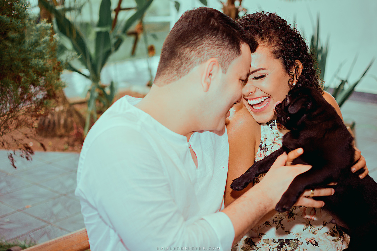 casal sorrindo e cachorrinho beijando a noiva