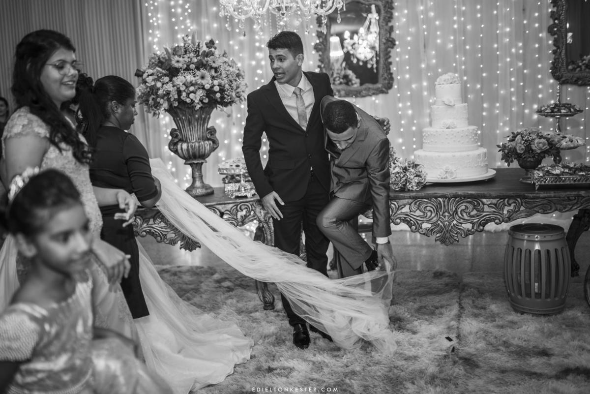 noivo pisando no véu da noiva em seu casamento