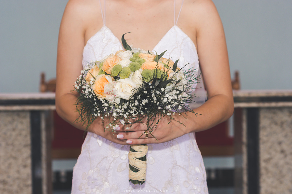 noiva segurando seu lindo buque natural em casamento durante o dia