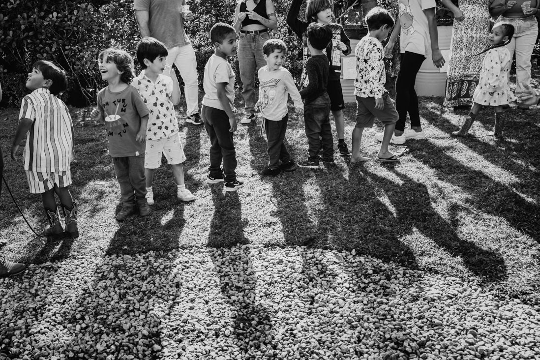 foto preto e branco de diversas crianças enfileiradas durante atividade recreativa em festa infantil no espaço jamboo no rj