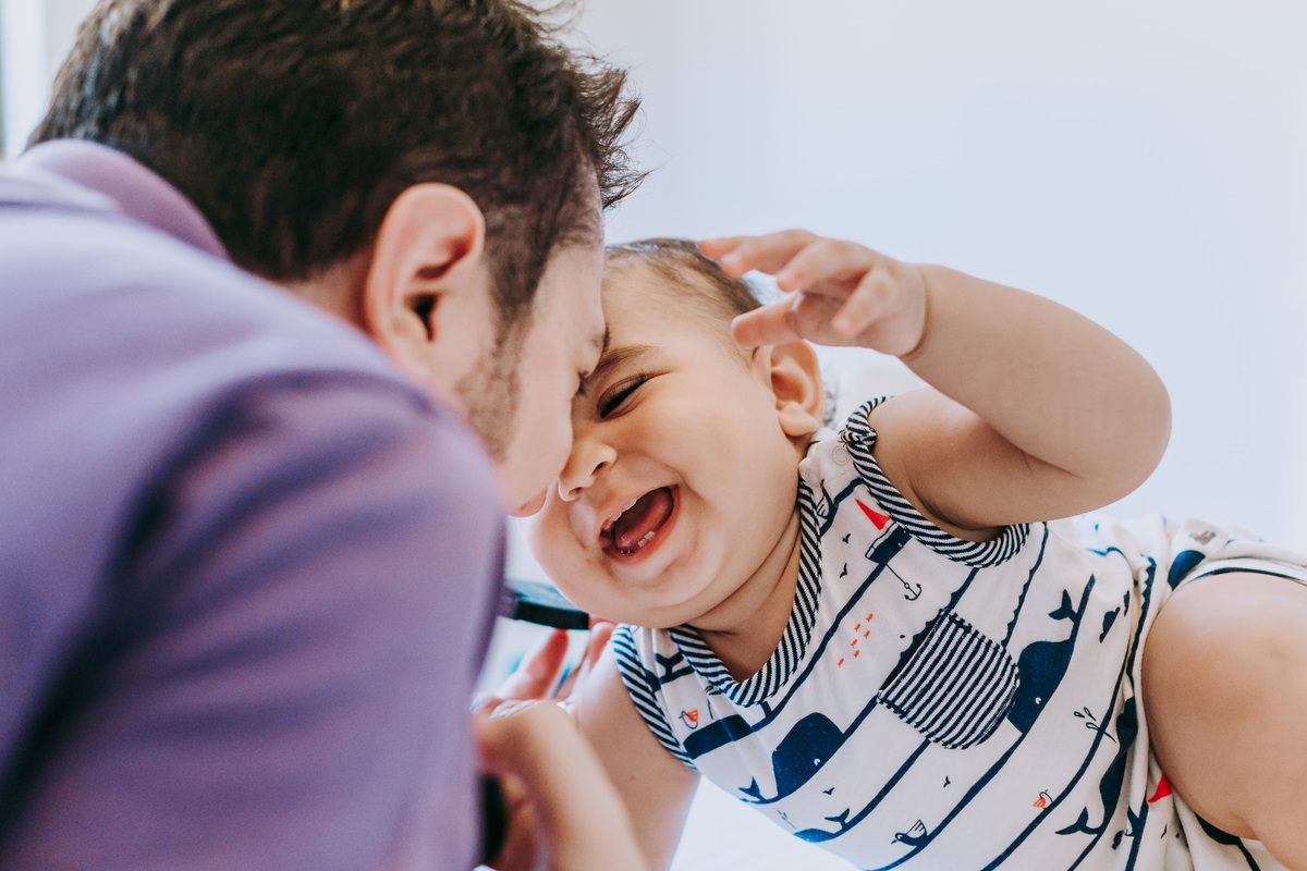 Fotografia de criança sorrindo com o pai