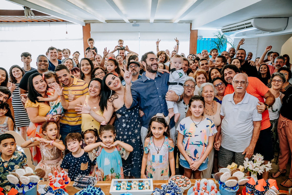familia reunida em frente a mesa do bolo na casa de festas vilarejo na barra da tijuca no rj