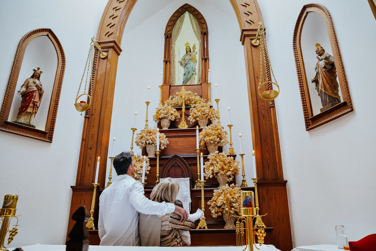 padrinhos de consagração apresentam criança a nossa senha no altar na paroquia nossa senhora da luz