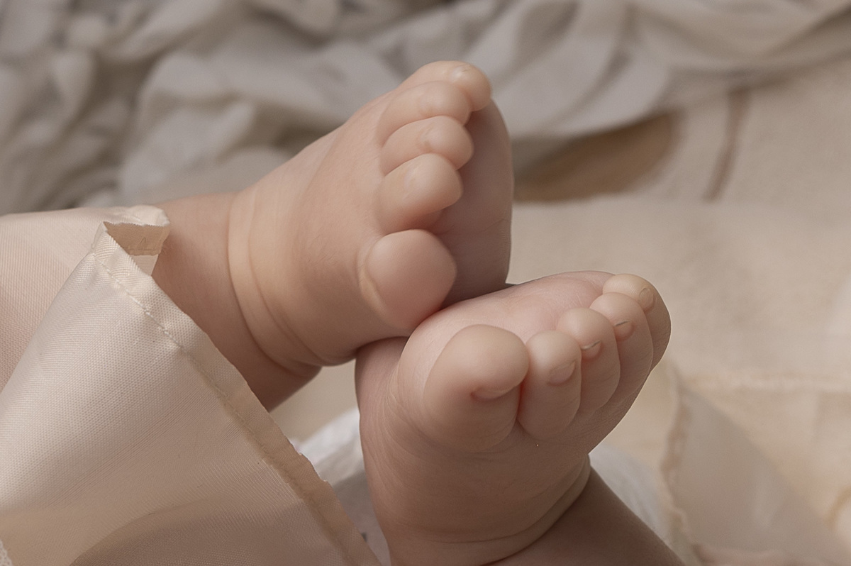 Detalle de sus pequeños pies, un recordatorio de lo frágil y valioso que es este comienzo en la vida de su bebé.