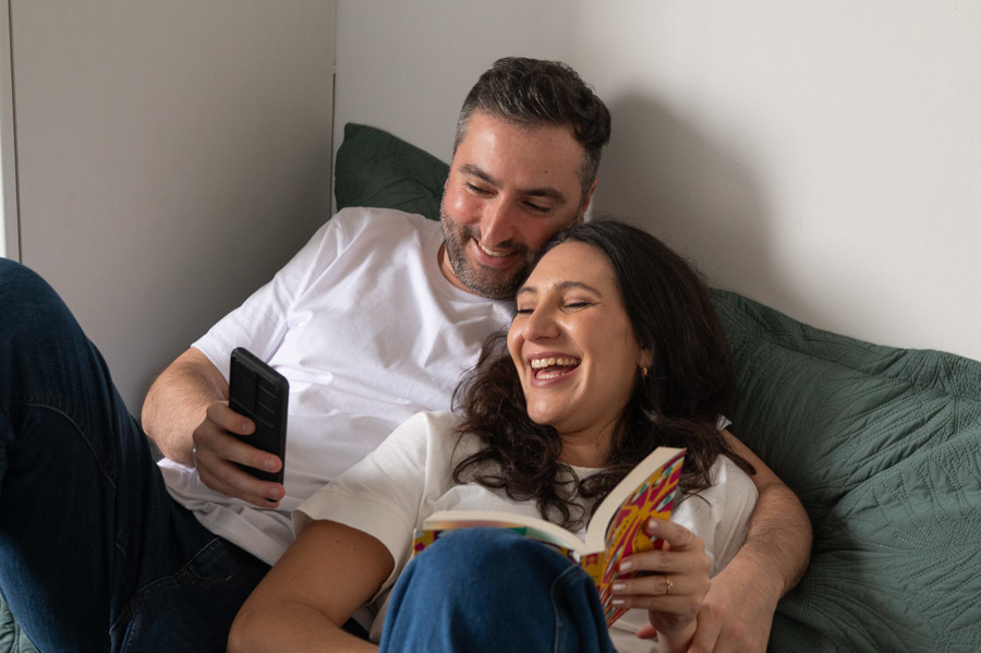 Cami y Lucas en la cama reindose. Fotografía de preboda lifestyle en Querétaro.