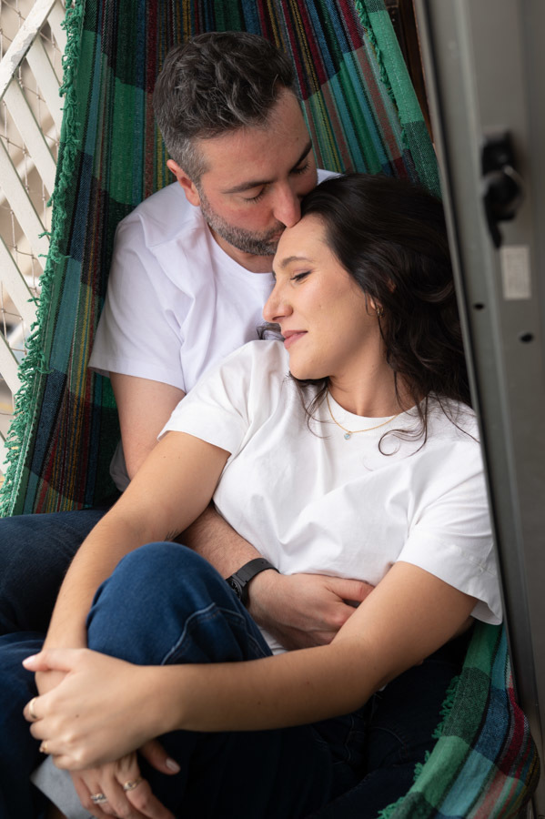 Cami y Lucas abrazados en la hamaca de su terraza. Fotos de preboda en casa en Querétaro.preboda en casa en Querétaro.