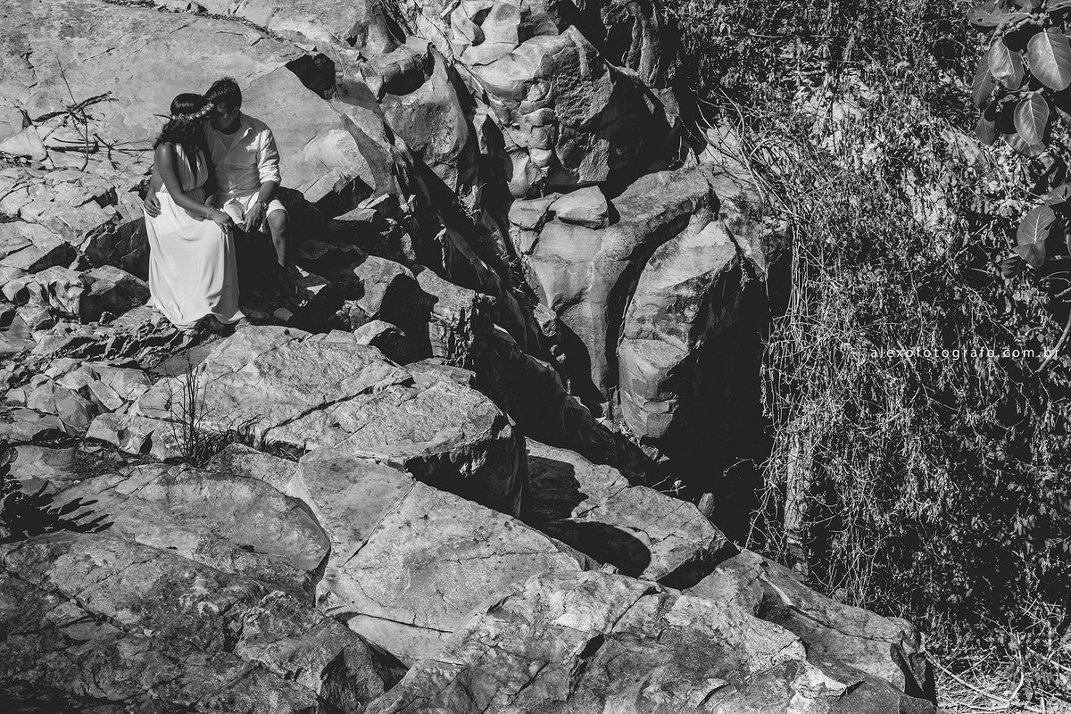 casal sentado nas pedras, fotografia preto e branca, com muita textura