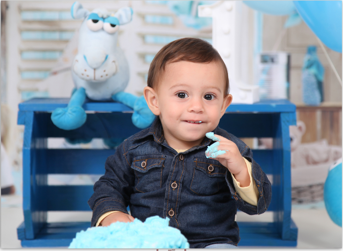 menino comendo bolo azul