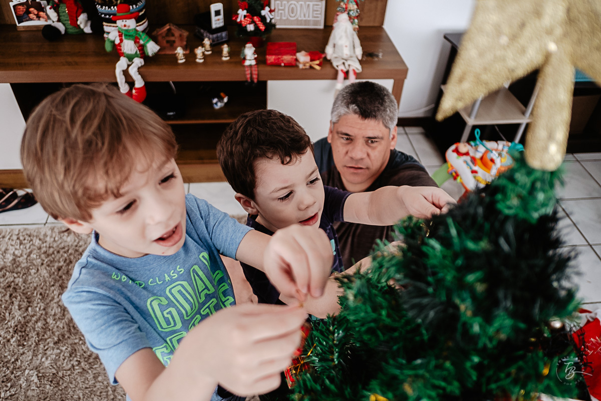 Filhos e papai montando a árvore de natal. Ensaio documental de Natal, em casa, por Thiago Braga fotografia. 