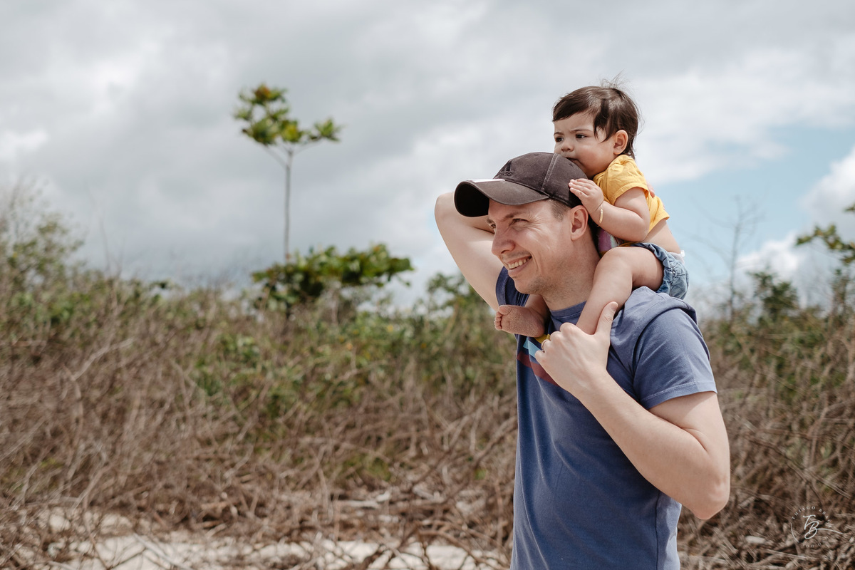 Sorrindo com o papai. Ensaio de família. Acompanhamento do primeiro aninho da Khloe. Praia da Daniela em Florianópolis/SC, por Thiago Braga Fotografia. 