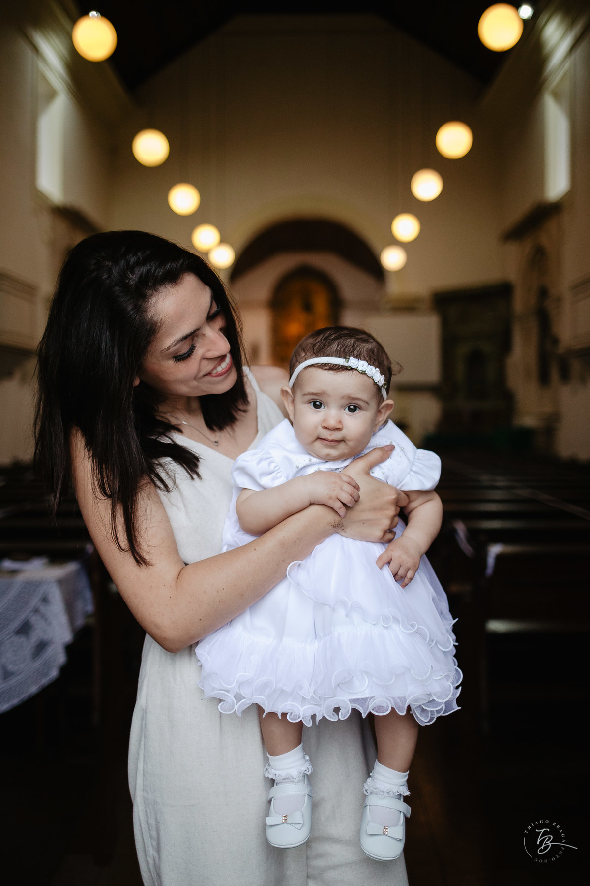 Com sua tia. O dia do batizado da Lara, na Igreja santuário da Imaculada conceição, na Lagoa em Florianópolis. - SC, por Thiago Braga Fotografia.