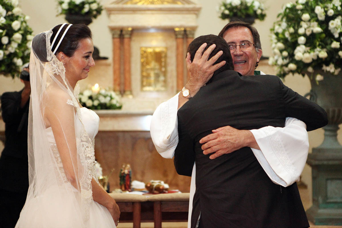 muita emoção do abraço do padre ao casal de noivos recém casados