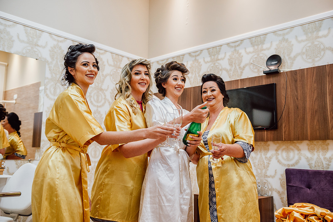 noiva estourando champanhe  no seu dia da noiva 