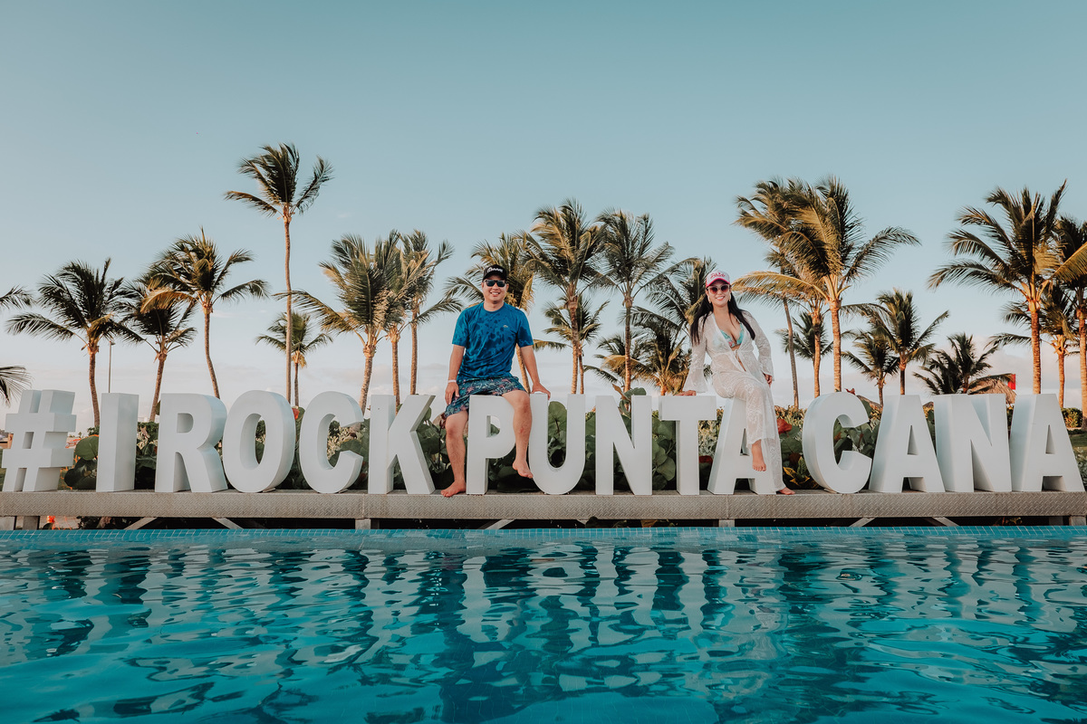 Ensaio de casal no hotel e casino Hard Rock Punta Cana fotos na pisicna com letreiro
