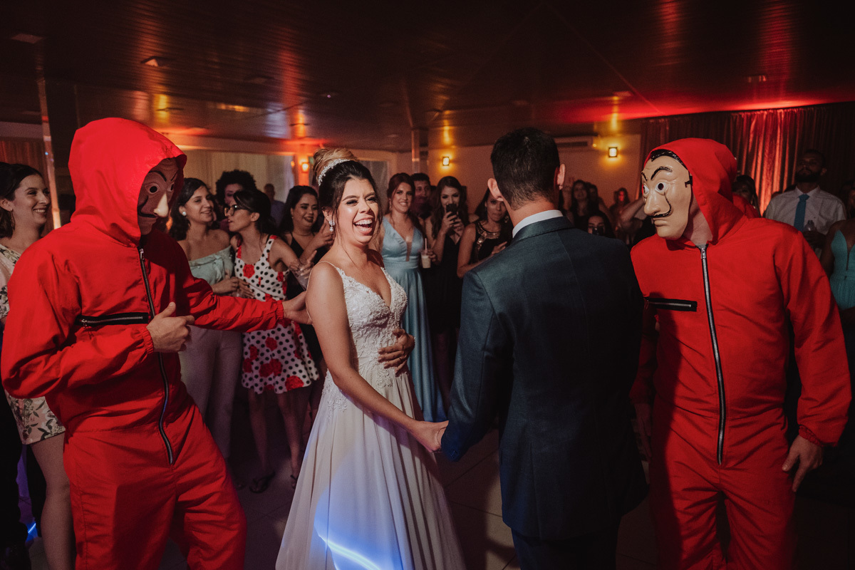 noivo faz surpresa para a noiva dançando musica com os padrinhos fantasiados 