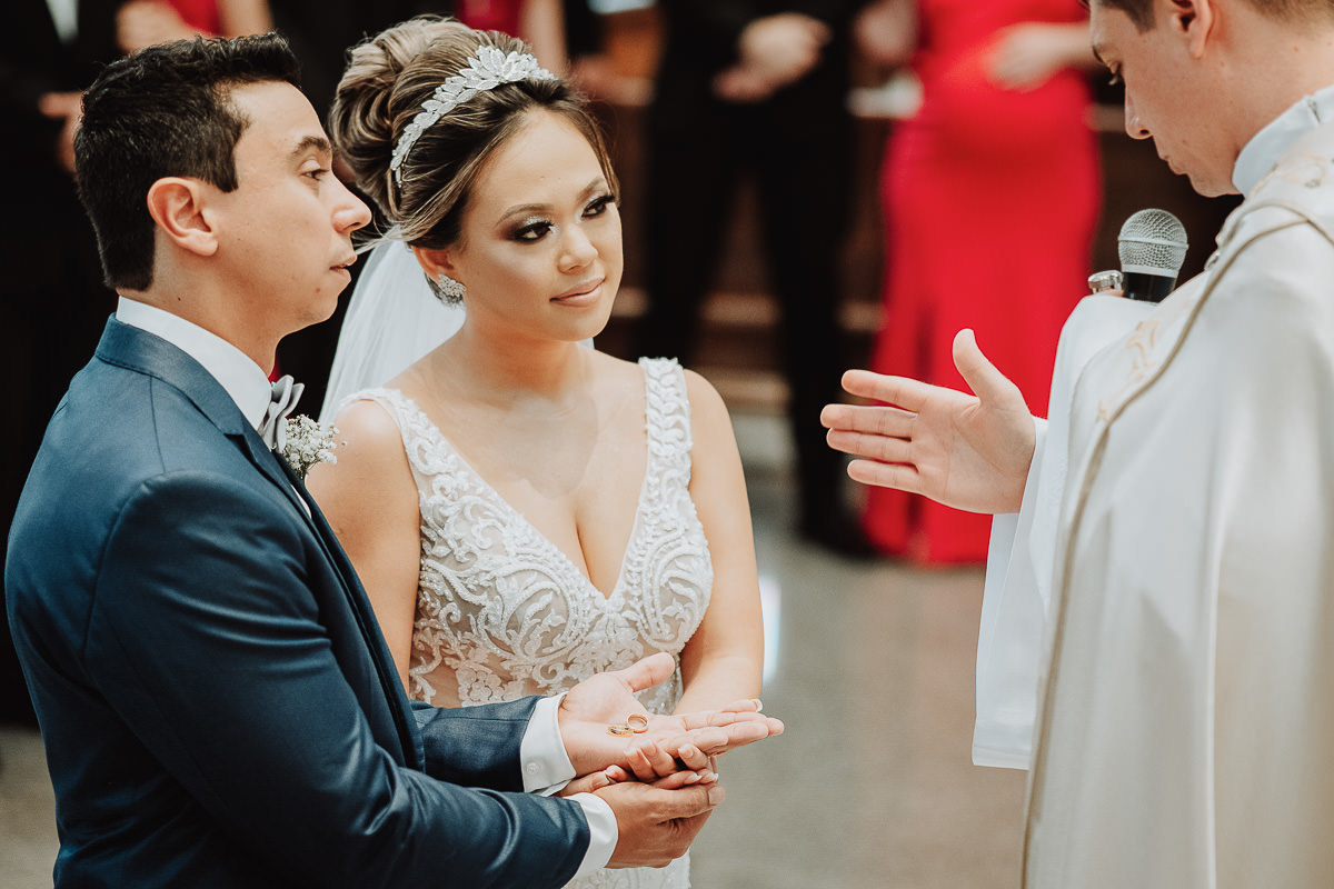 padre abençoando as alianças em cerimonia de casamento catolico em maringa 