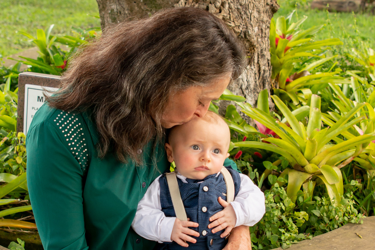 vovó fazendo carinho no bebê após batizado