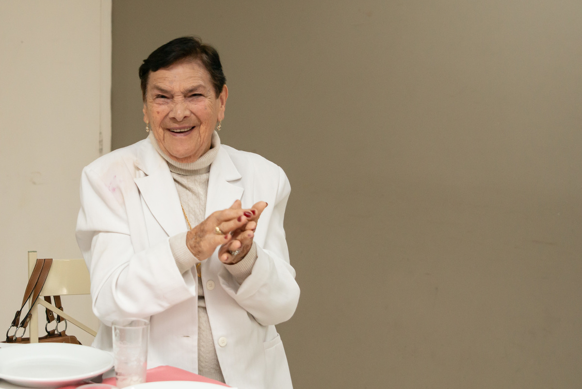 idosa batendo palmas em sua festa de aniversário de 90 anos