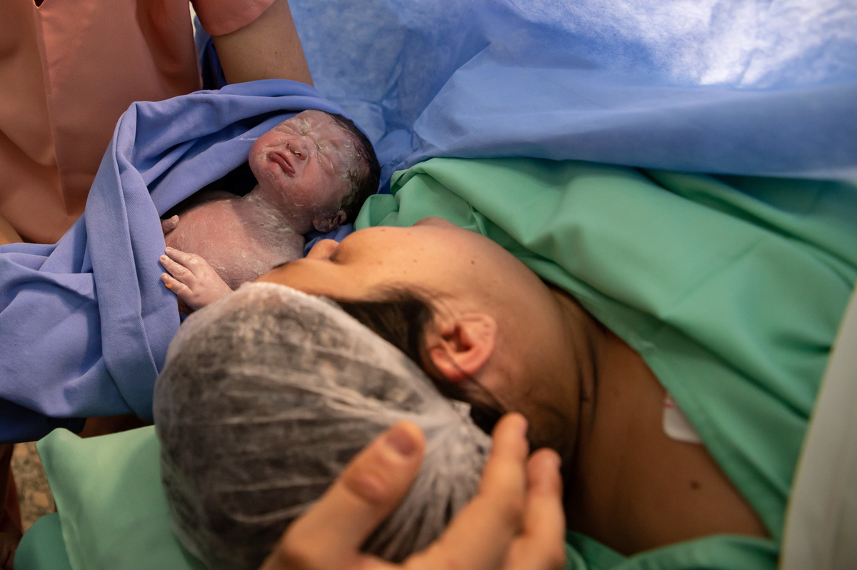 bebê após o parto fazendo beicinho com a mãe