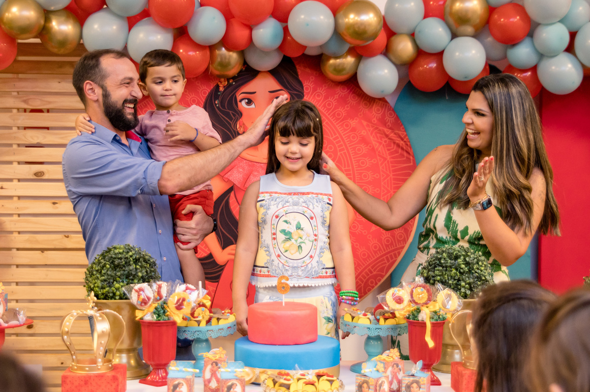 Festa de aniversário infantil, ganhando um carinho dos pais na mesa decorada Elena de Avalor
