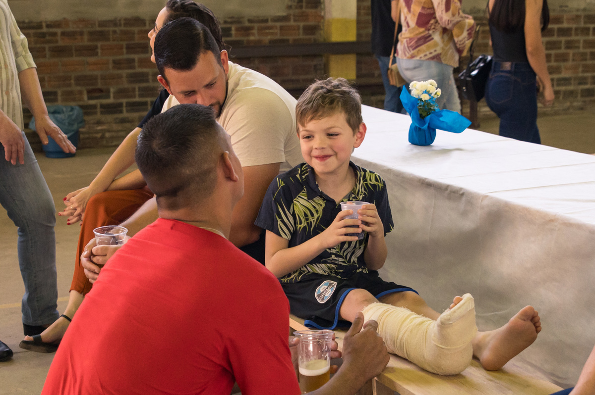 Festa de Primeira Comunhão - Muda Boi - criança com o pé machucado sendo paparicada