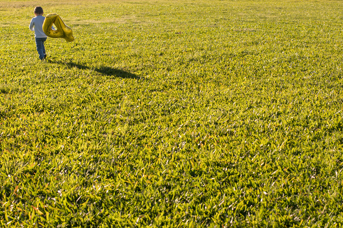 ensaio de família, criança correndo com um balão de 4 anos