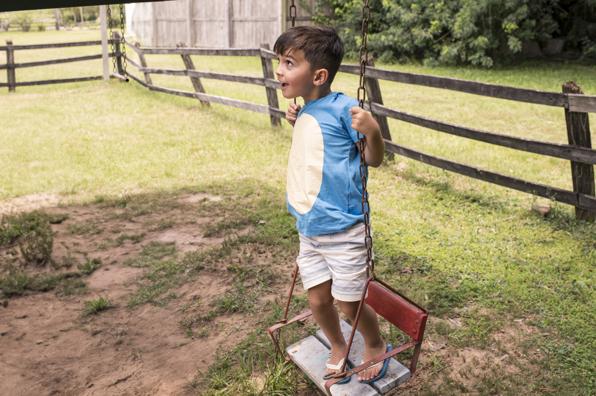 Festa de aniversário infantil criança brincando no balanço
