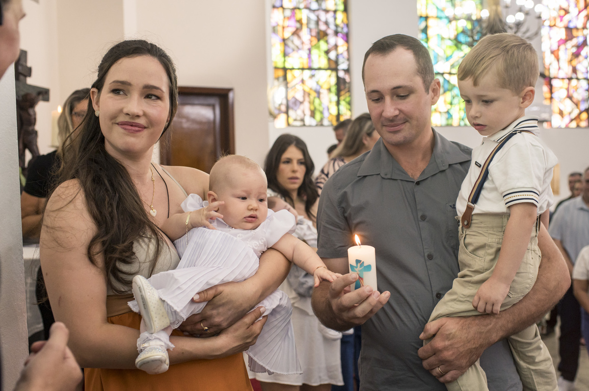 pais recebendo a vela batismal na igreja luterana