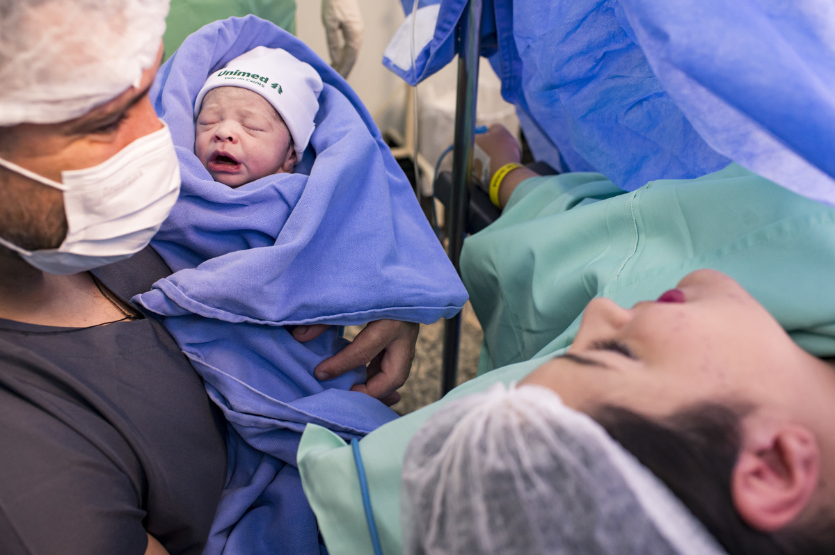 Documental de parto/cesária no hospital Unimed Vale do Caí, mostrando o bebê para a mãe