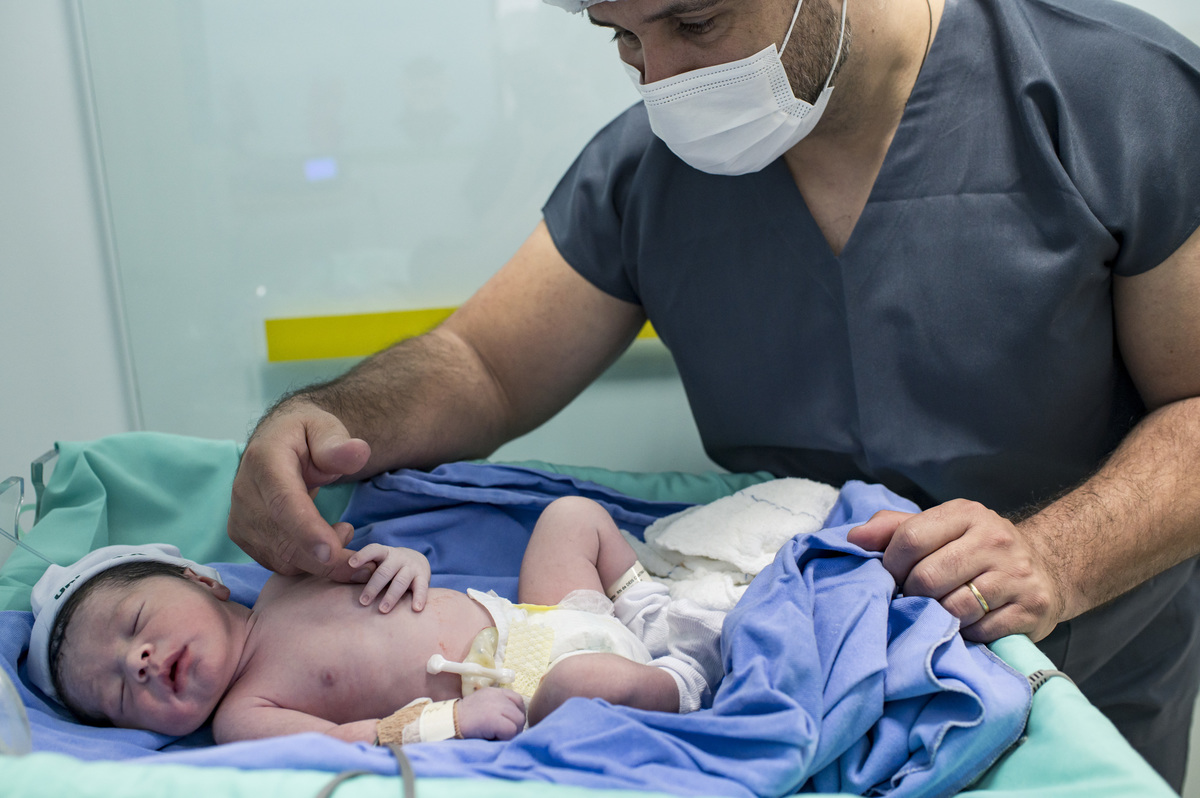 Documental de parto/cesária no hospital Unimed Vale do Caí, pai cuidando do bebê
