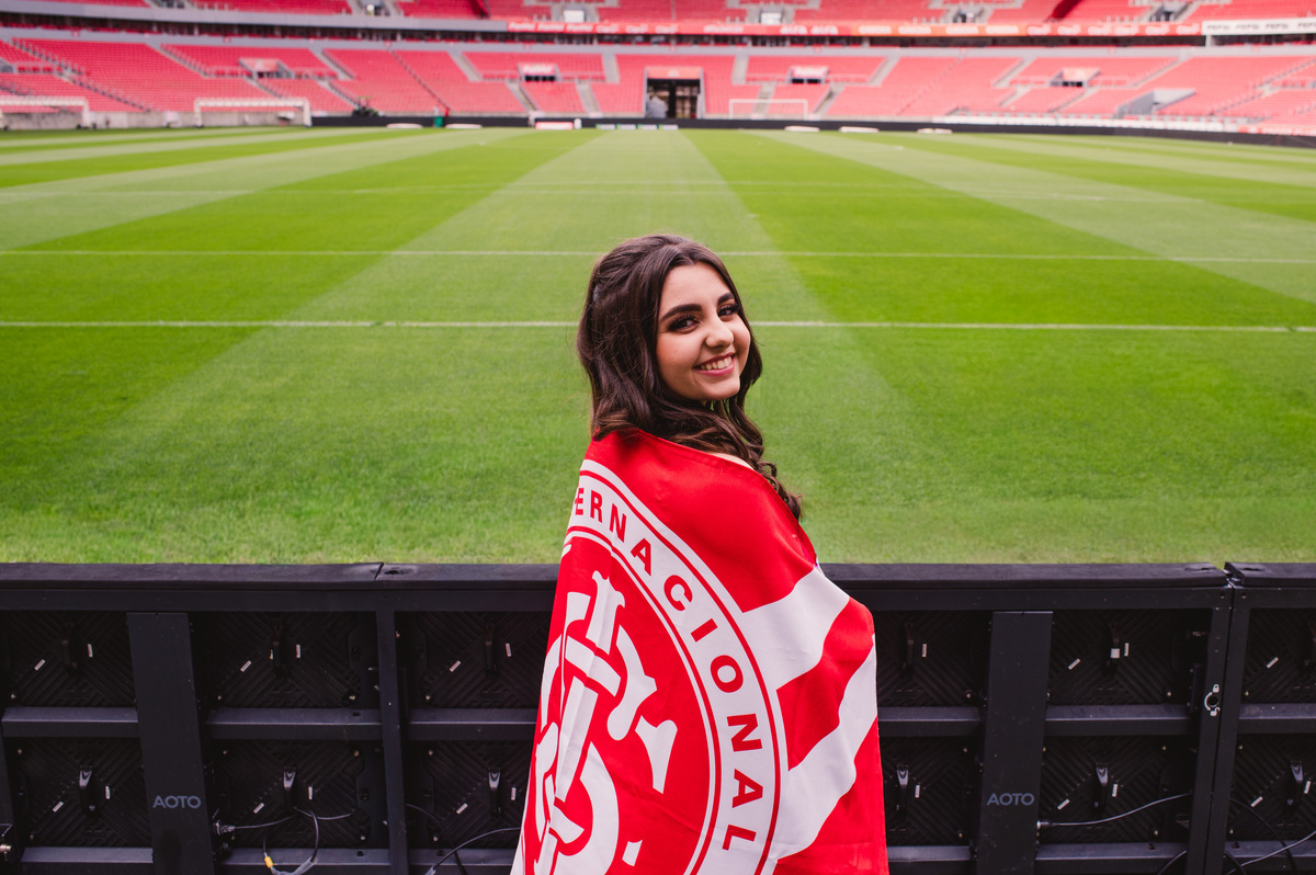 Ensaio fotográfico pré 15 anos no estádio Beira Rio - fotógrafa Claudia Wallauer - debutante com bandeira do internacional sport club