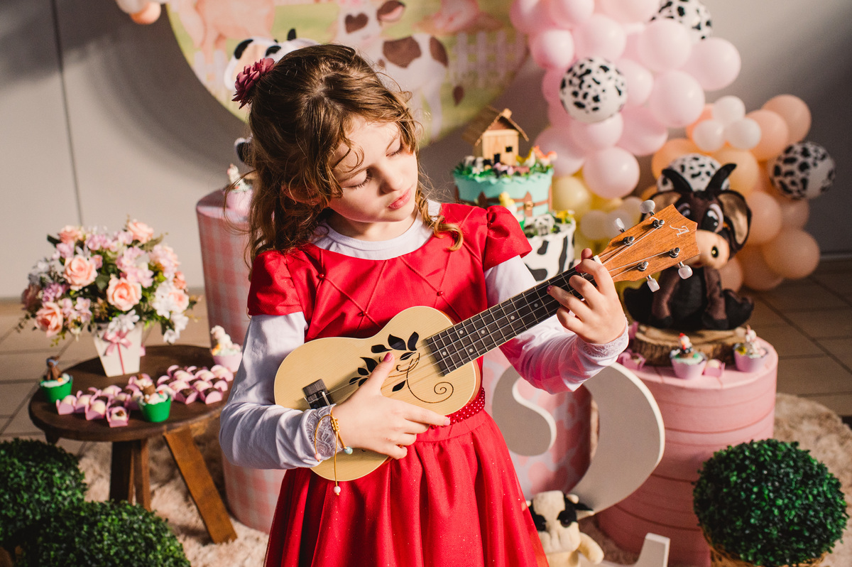 Festa de aniversário infantil em Brochier, fotógrafa Claudia Wallauer, mana tocando Ukulele